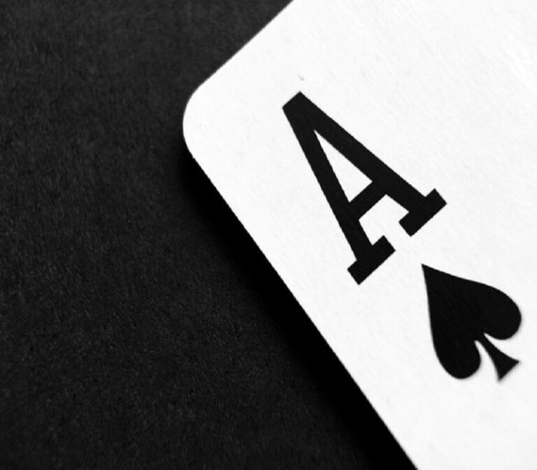 Close-up of the Ace of Spades card on a black background.